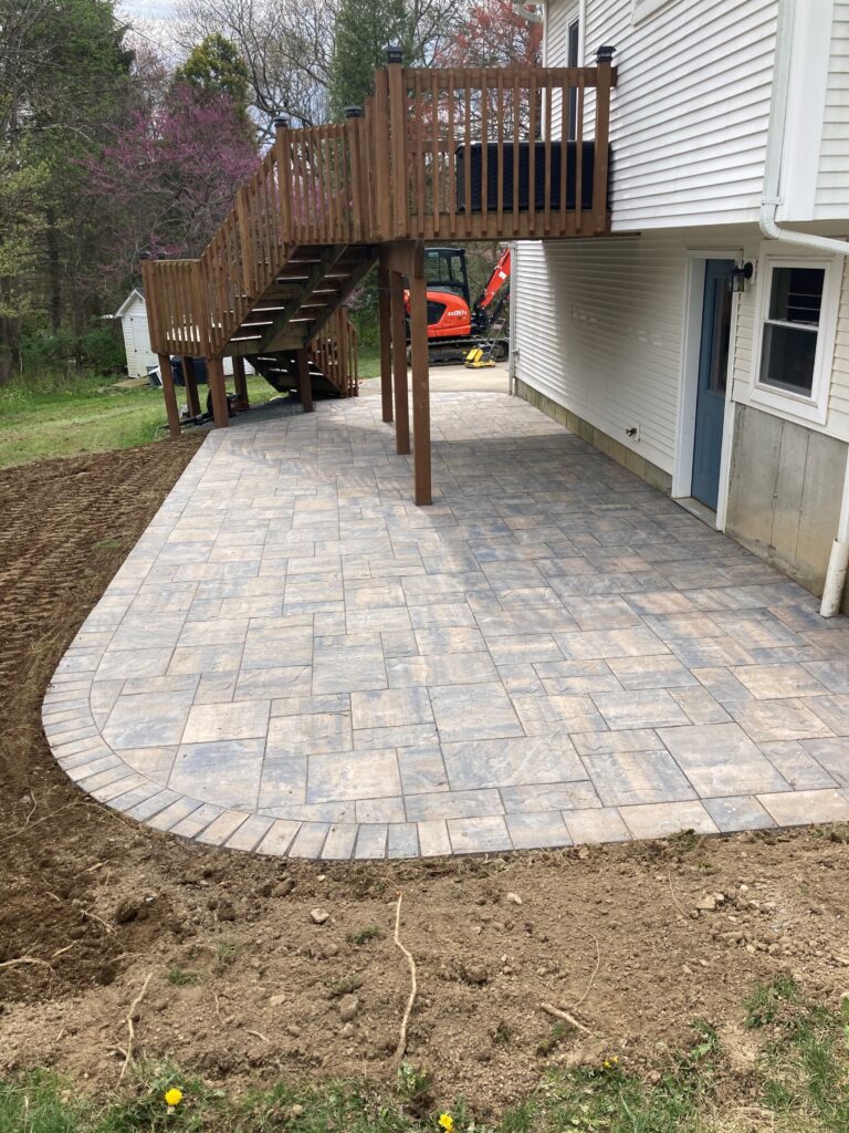 Beautiful stone patio wrapping around back of house - view 2 Cranehill Contracting